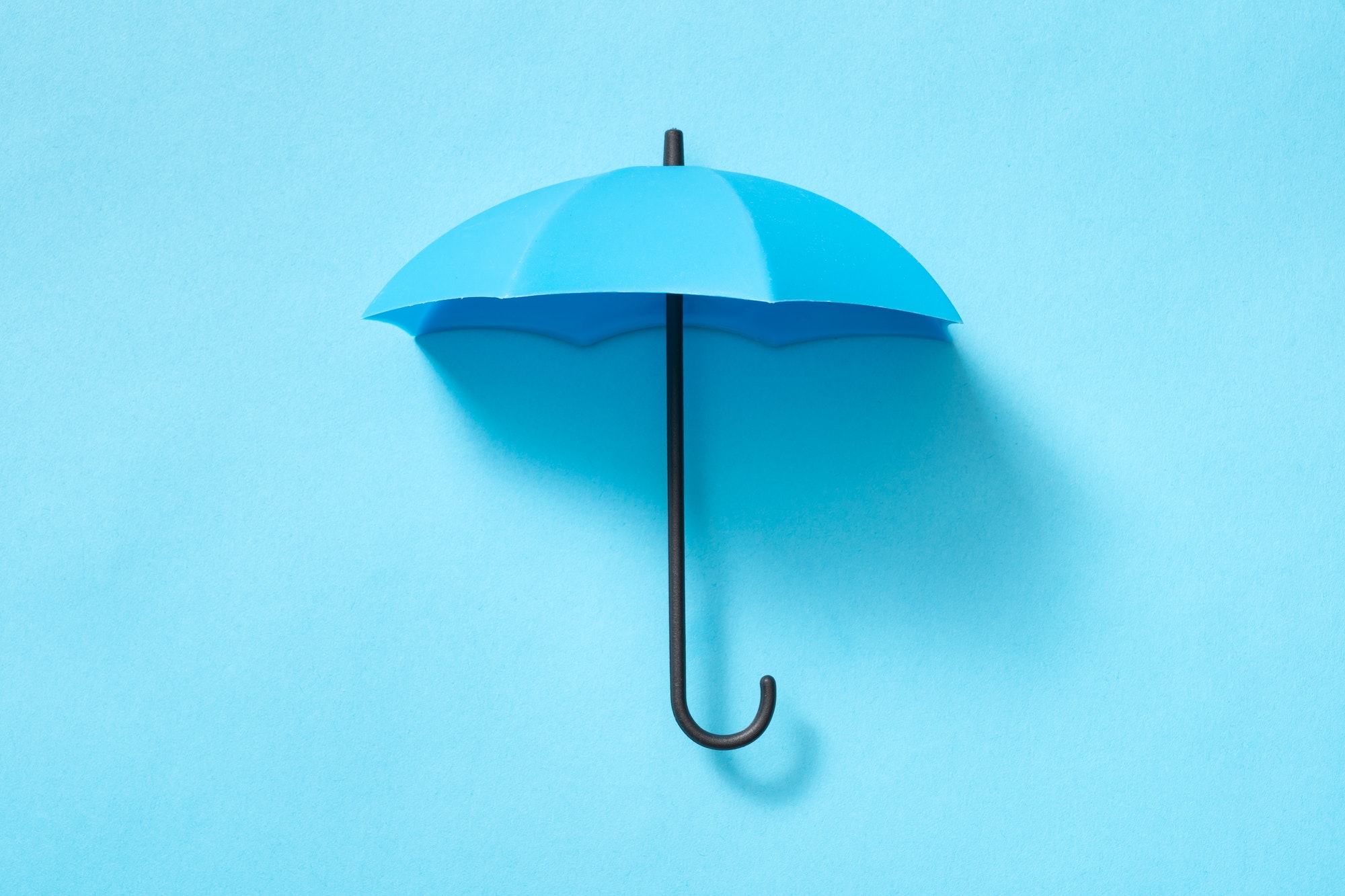 Blue umbrella isolated on blue background